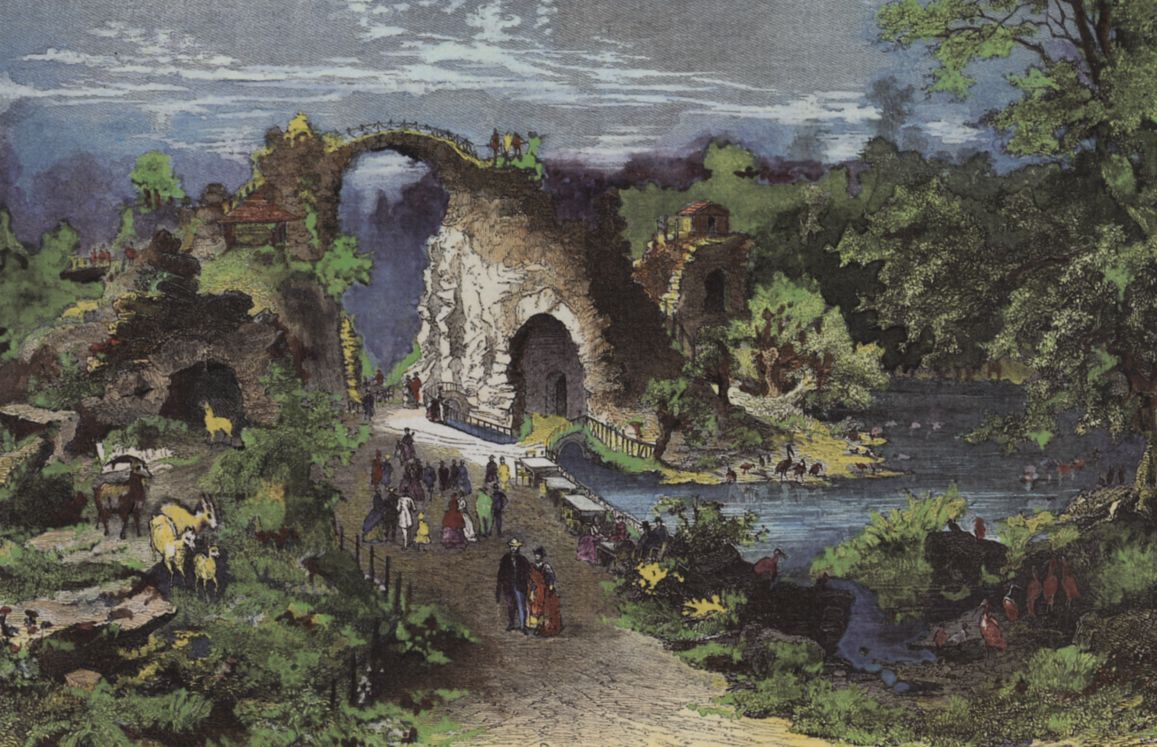 Walkers in front of an artificial landscape of ruins with bridge, rocks and pond in a historical park.