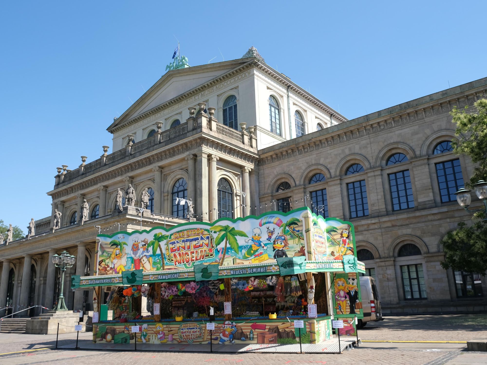 Duck fishing" stall in front of the Hanover Opera House under a blue sky during the City Fair.